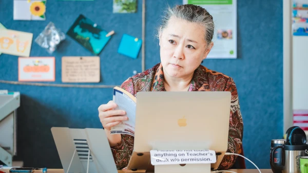 female teacher listening to students at chengdu international school high school