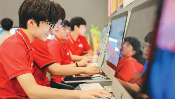 male students studying about chengdu international school computers in their classroom