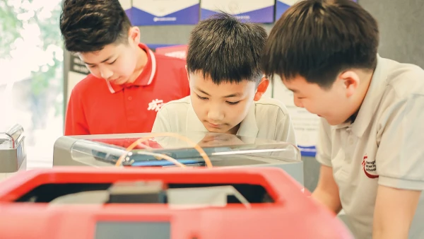three curious male students learning at chengdu international school elementary