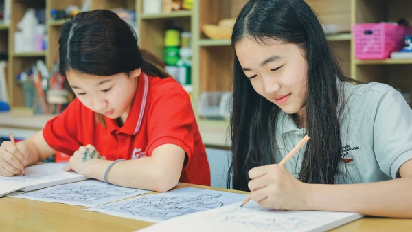 two studious female students drawing inside chengdu international school elementary