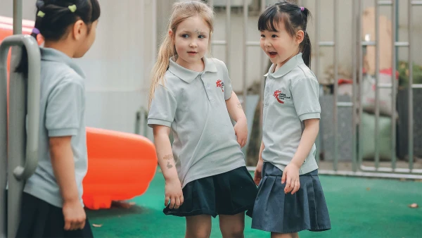 three female students outside chengdu international school learning together on the playground