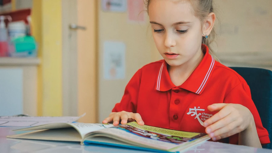 young female student reading a book about chengdu international school