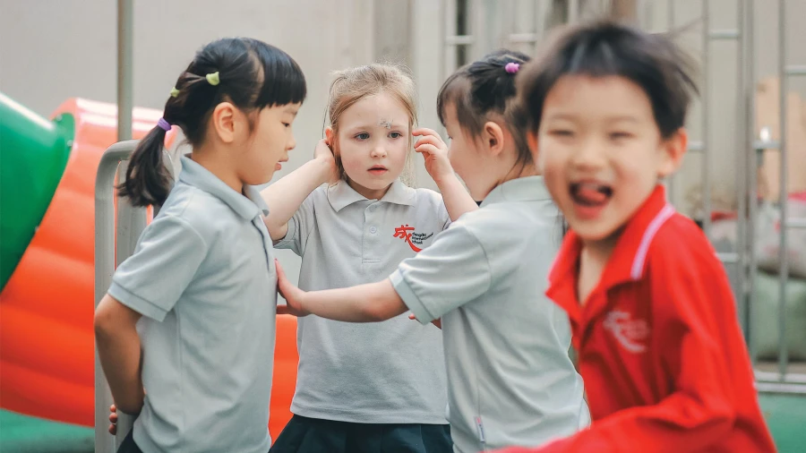 young chengdu international school students playing outside on the playground